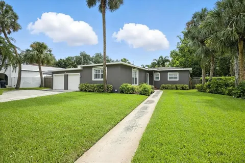 a view of a house with a yard and a garden