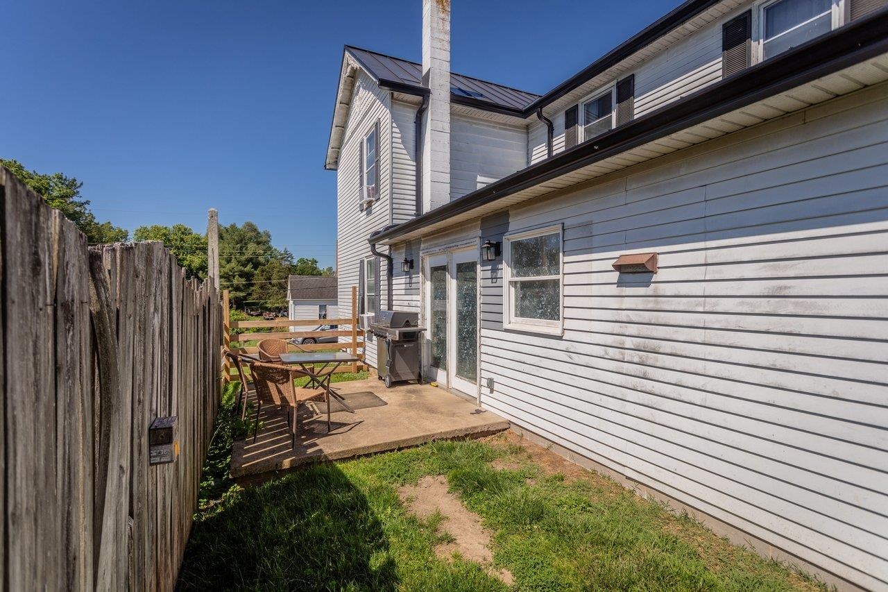 420 West Spring Street Woodstock, VA 22664 - Photo 58 of 67 a view of a patio with a table and chairs a barbeque with wooden fence
