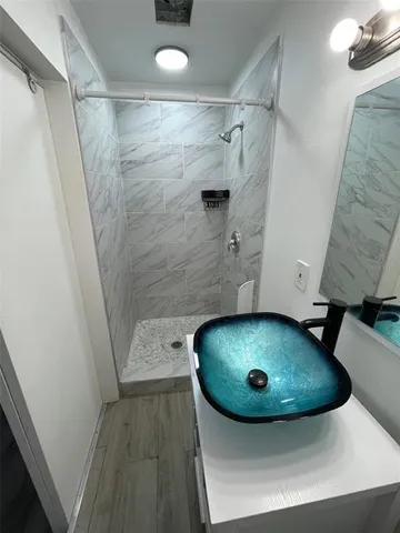 a bathroom with a double vanity sink and a mirror
