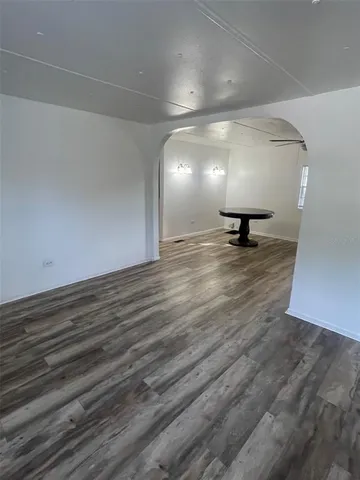 a view of a room with wooden floor