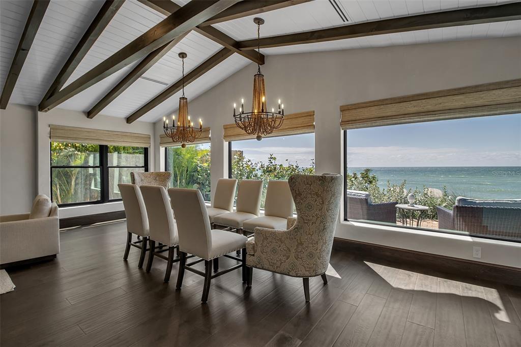 121 North Casey Key Road Osprey, FL 34229 - Photo 11 of 63 a view of a dining room with furniture window and wooden floor