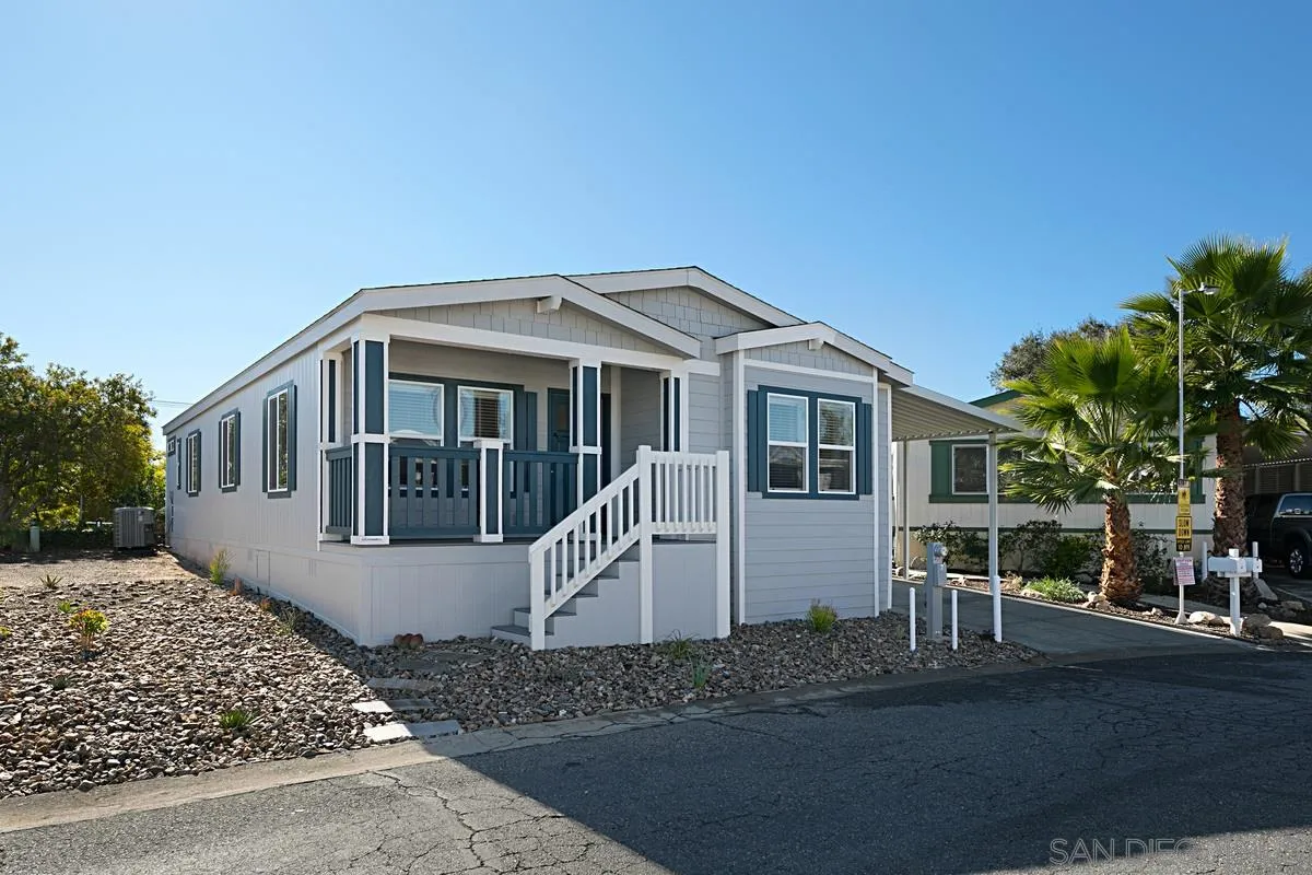 1120 East Mission Road, Unit 7 Fallbrook, CA 92028 - Photo 1 of 24 a front view of a house with a yard