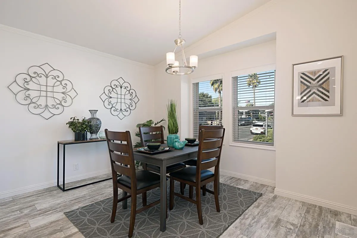1120 East Mission Road, Unit 7 Fallbrook, CA 92028 - Photo 12 of 24 a view of a dining room with furniture window and wooden floor