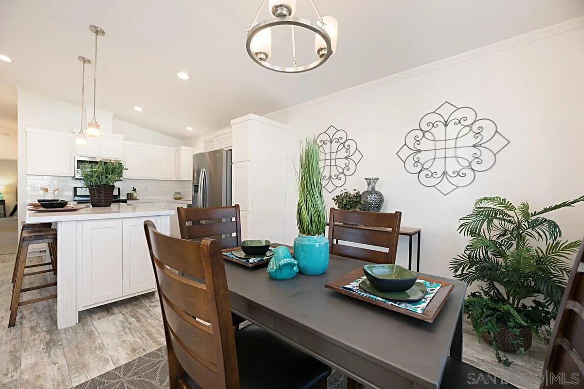 1120 East Mission Road, Unit 7 Fallbrook, CA 92028 - Photo 13 of 24 a dining room with furniture and a potted plant