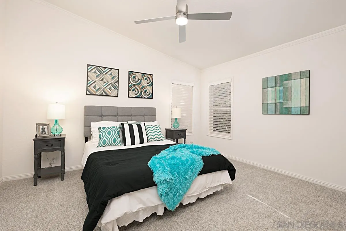 1120 East Mission Road, Unit 7 Fallbrook, CA 92028 - Photo 14 of 24 a bedroom with a bed and a couch