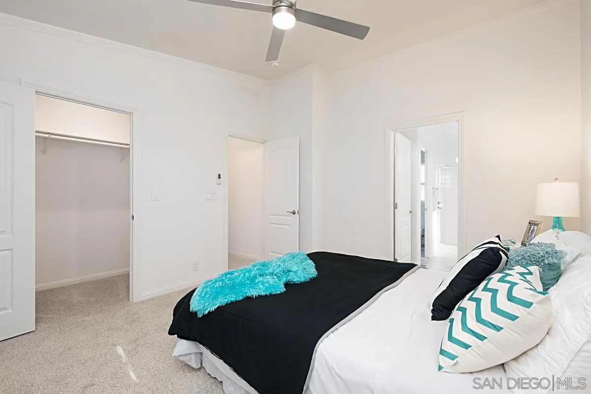 1120 East Mission Road, Unit 7 Fallbrook, CA 92028 - Photo 15 of 24 a bedroom with a bed and a chandelier