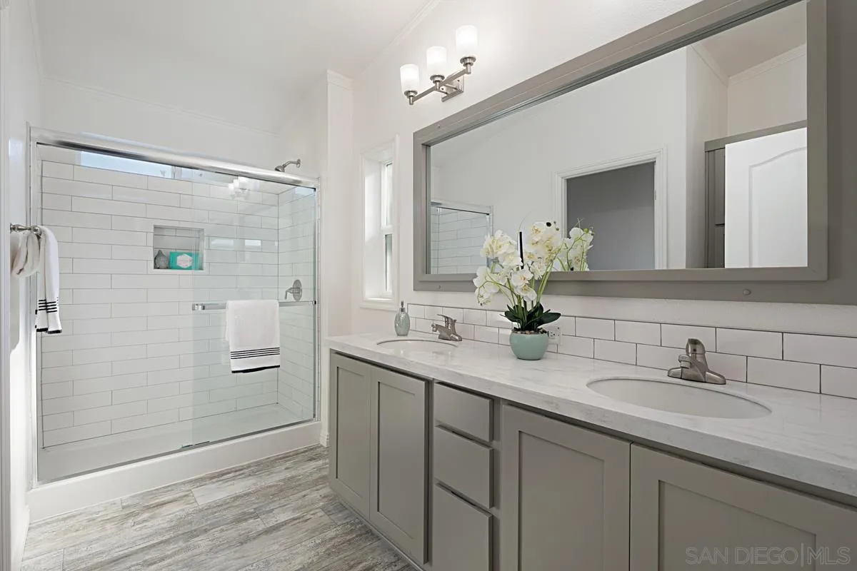 1120 East Mission Road, Unit 7 Fallbrook, CA 92028 - Photo 17 of 24 a bathroom with a double vanity sink mirror and shower