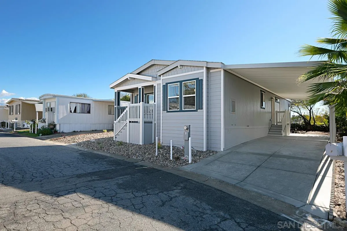 1120 East Mission Road, Unit 7 Fallbrook, CA 92028 - Photo 3 of 24 a front view of a house with a yard