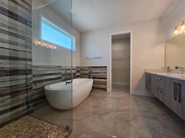 a bathroom with a bathtub sink and mirror