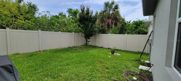 a garden with trees in front of it