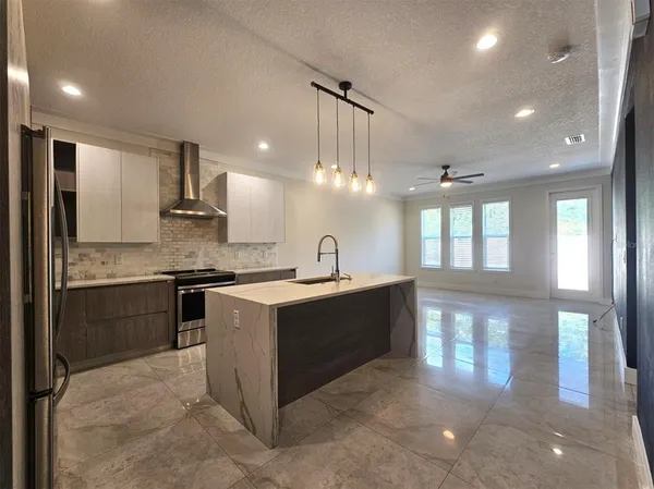 a large white kitchen with a large window