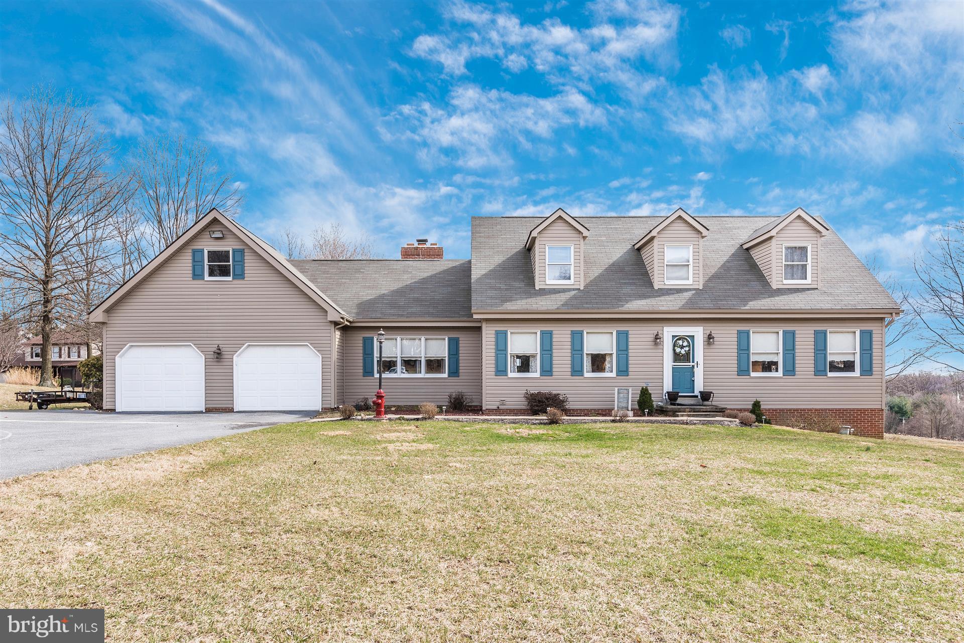 8717 Indian Springs Road Frederick, MD 21702 - Photo 1 of 24 a front view of a house with a yard