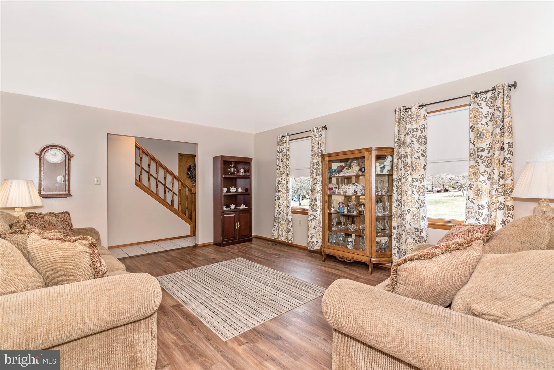 8717 Indian Springs Road Frederick, MD 21702 - Photo 12 of 24 a living room with furniture and a rug