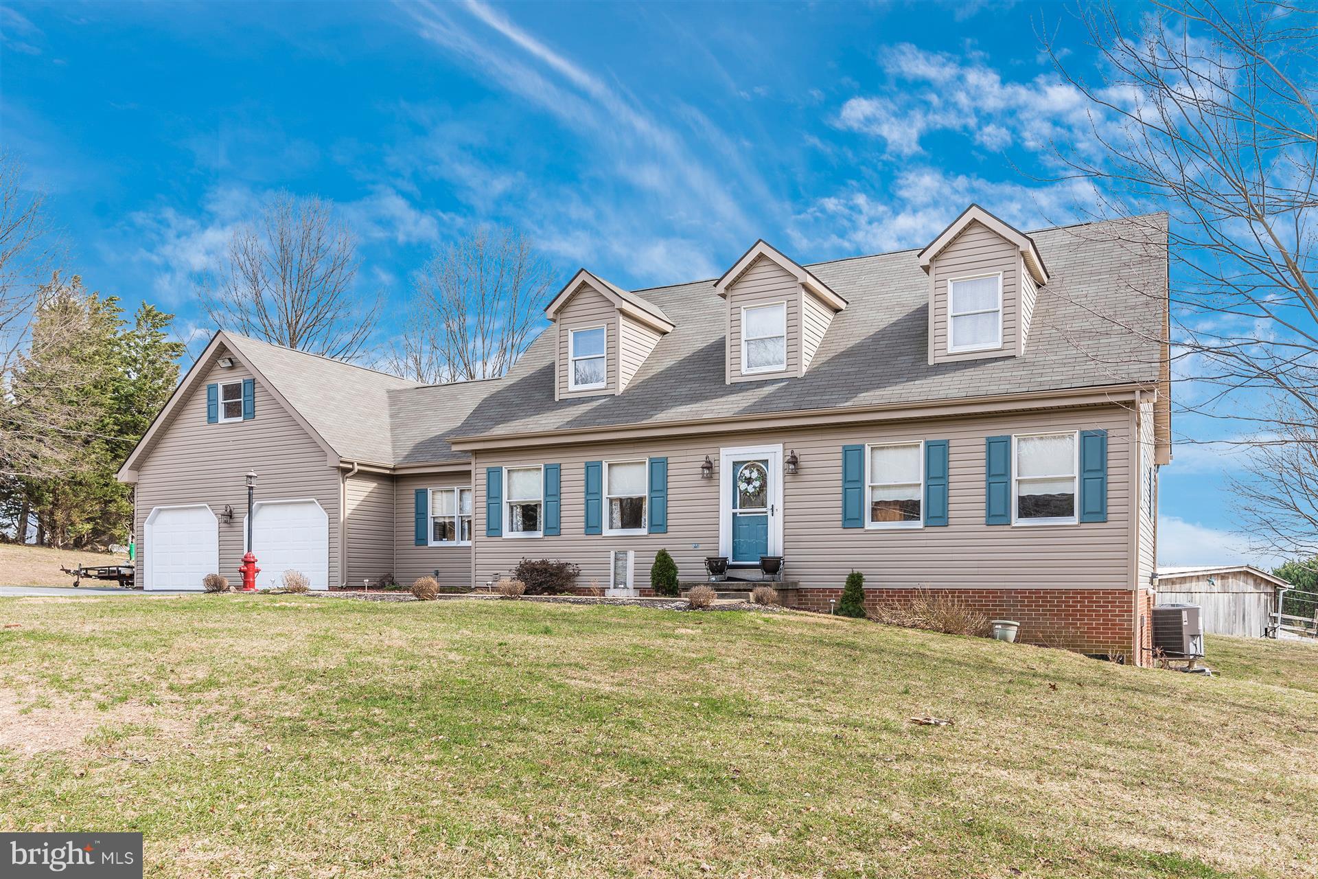 8717 Indian Springs Road Frederick, MD 21702 - Photo 20 of 24 a front view of house with yard and trees around