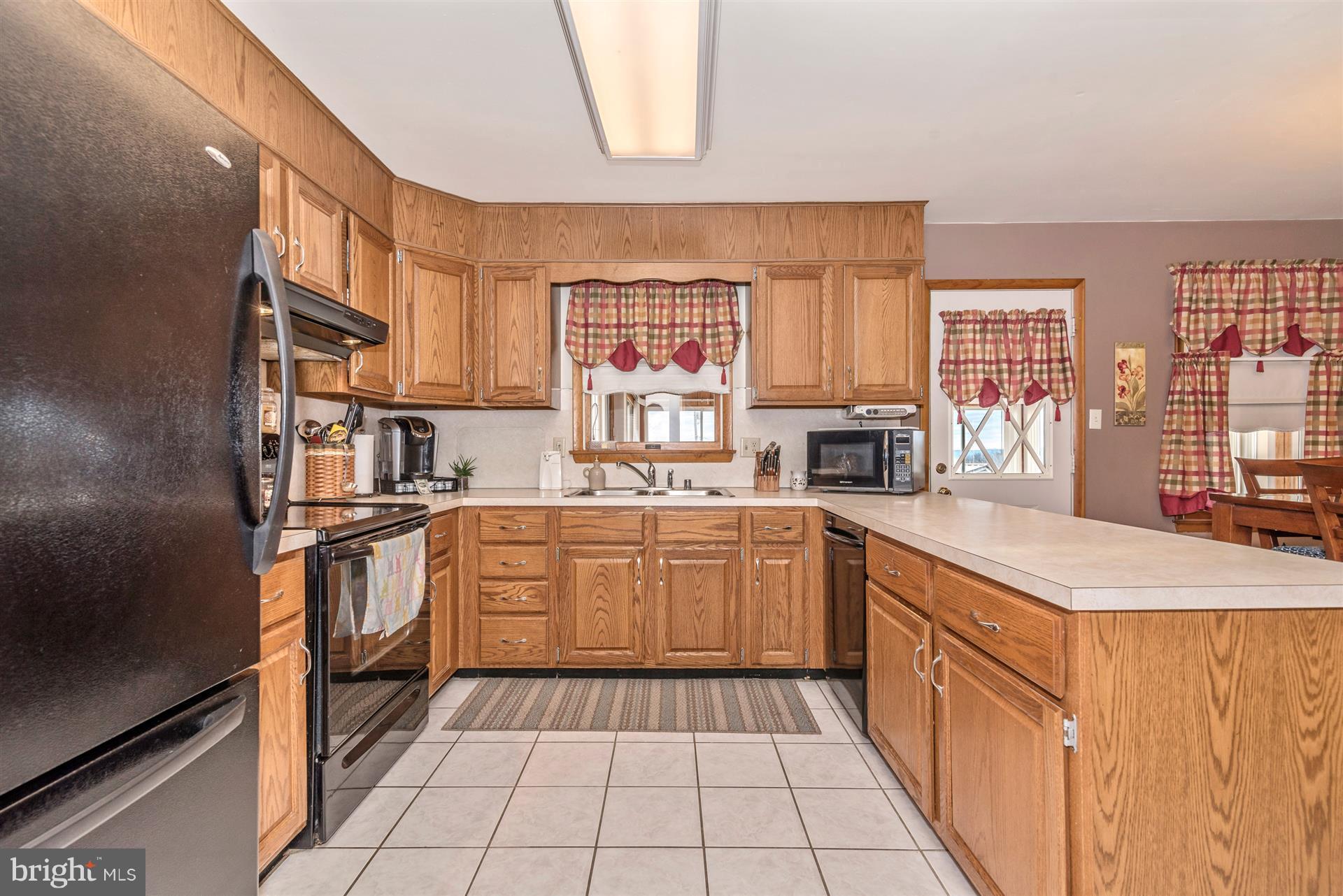 8717 Indian Springs Road Frederick, MD 21702 - Photo 23 of 24 a kitchen with stainless steel appliances granite countertop a stove top oven a sink a counter space and cabinets