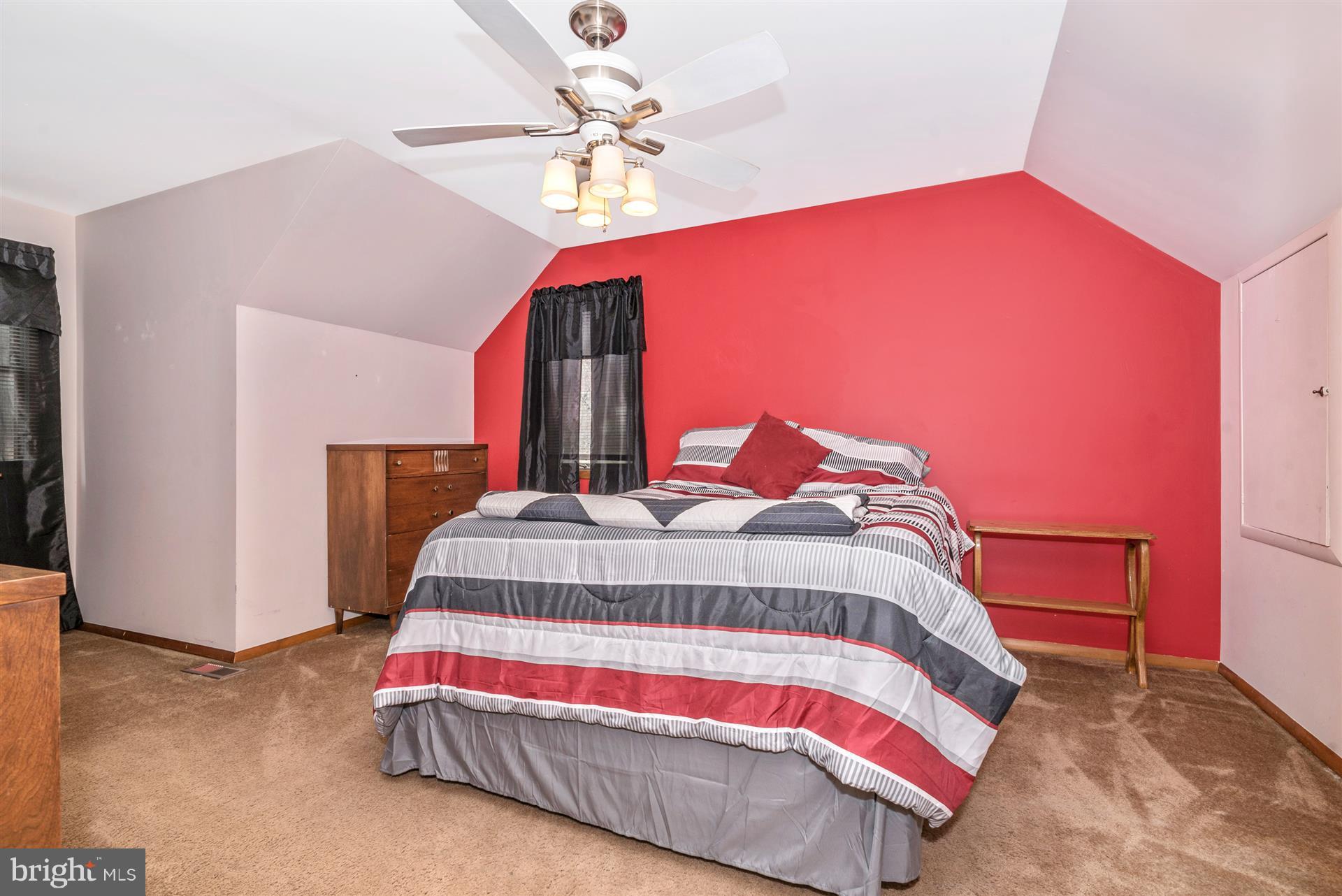 8717 Indian Springs Road Frederick, MD 21702 - Photo 5 of 24 a bedroom with a bed and lamp