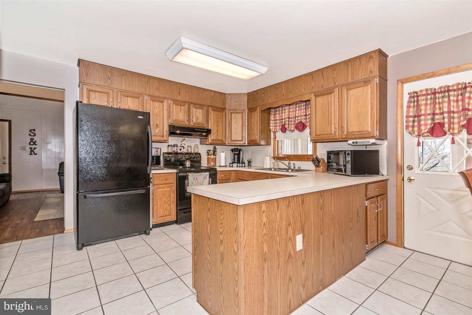 8717 Indian Springs Road Frederick, MD 21702 - Photo 9 of 24 a kitchen with stainless steel appliances granite countertop a refrigerator stove and a sink