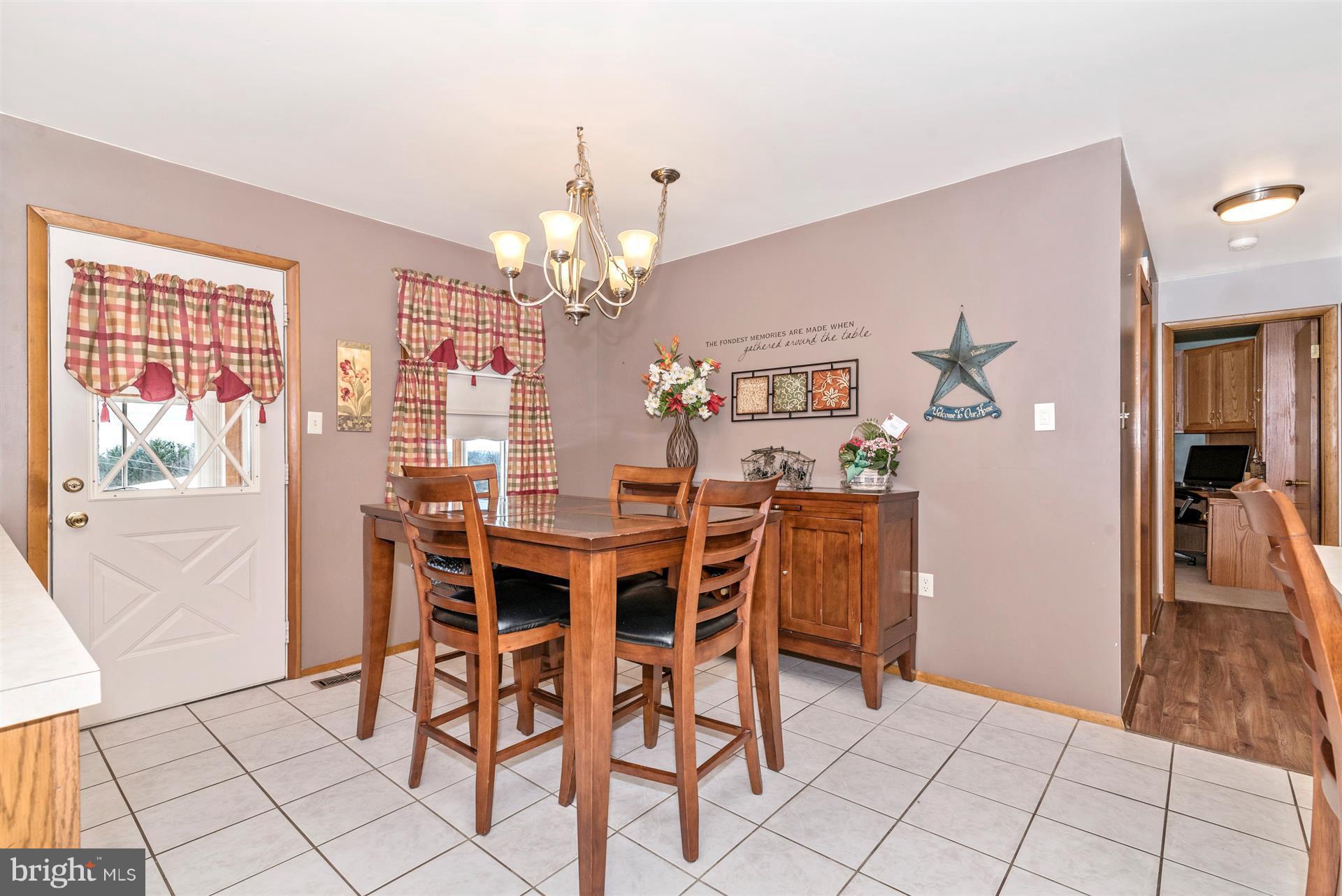 8717 Indian Springs Road Frederick, MD 21702 - Photo 10 of 24 a view of a dining room with furniture and chandelier