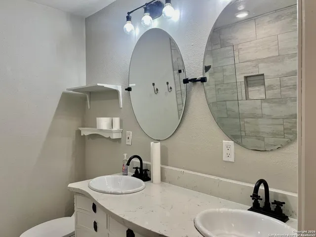 a bathroom with a sink and a mirror