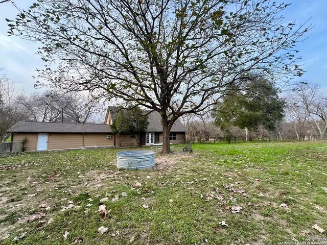 a view of a yard with a house in the background