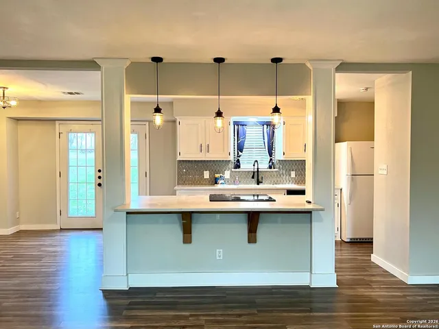 a view of kitchen sink and wooden floor