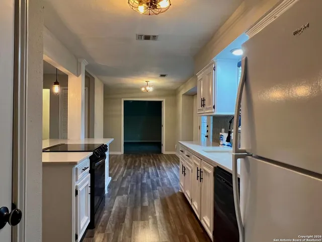 a kitchen with stainless steel appliances granite countertop a stove and a refrigerator