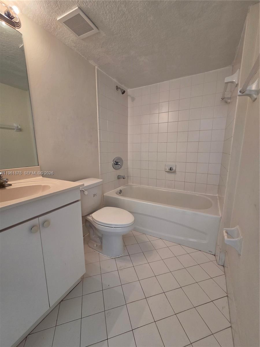 1251 Southeast 29th Street, Unit 10326 Homestead, FL 33035 - Photo 11 of 17 a bathroom with a sink a toilet and shower