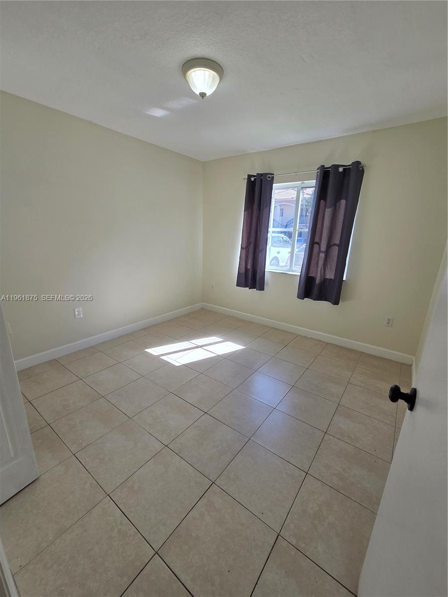 1251 Southeast 29th Street, Unit 10326 Homestead, FL 33035 - Photo 13 of 17 a view of an empty room and window