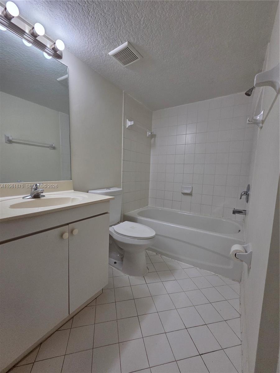 1251 Southeast 29th Street, Unit 10326 Homestead, FL 33035 - Photo 9 of 17 a bathroom with a sink a toilet and shower