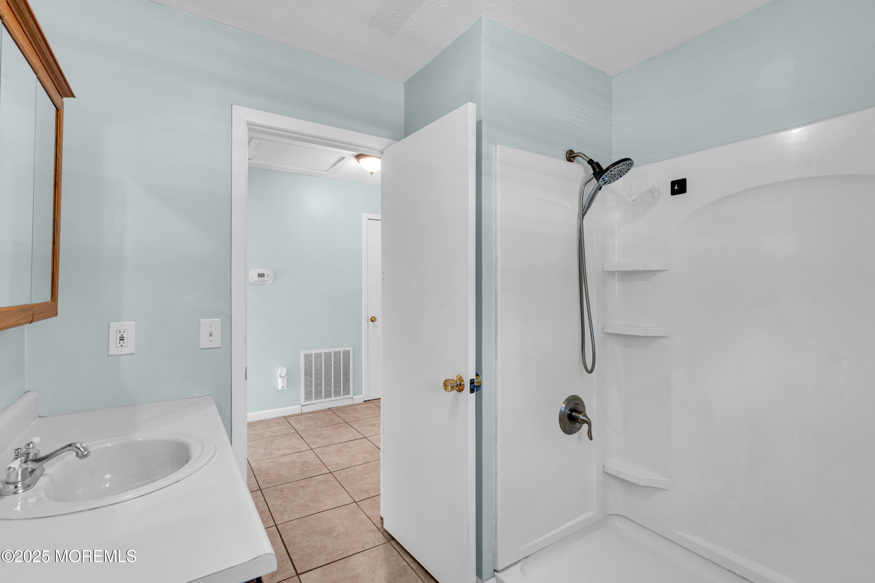47 Kitty Court Brick, NJ 08724 - Photo 11 of 17 a bathroom with a tub shower sink and vanity