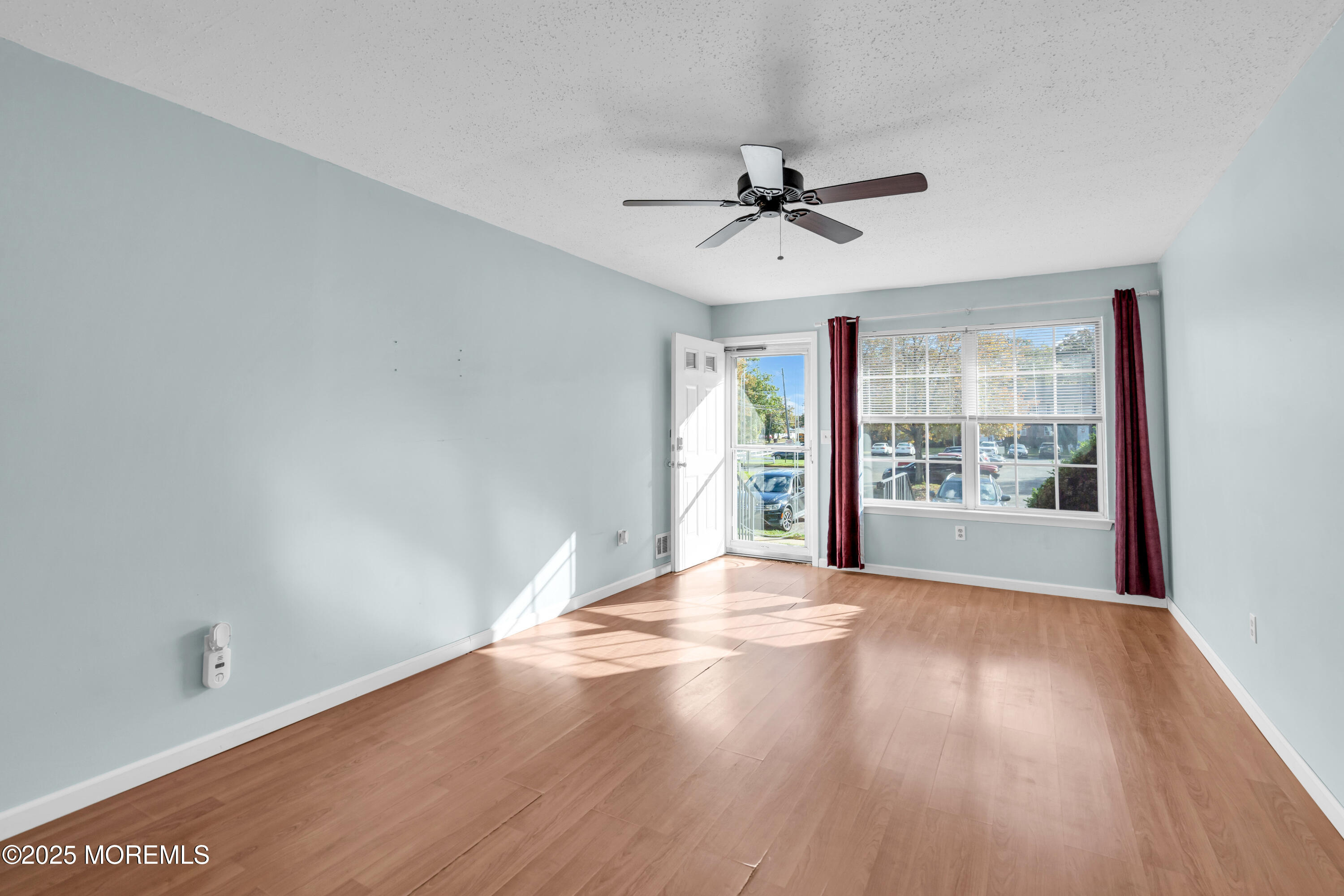 47 Kitty Court Brick, NJ 08724 - Photo 3 of 17 a view of an empty room with a window and wooden floor