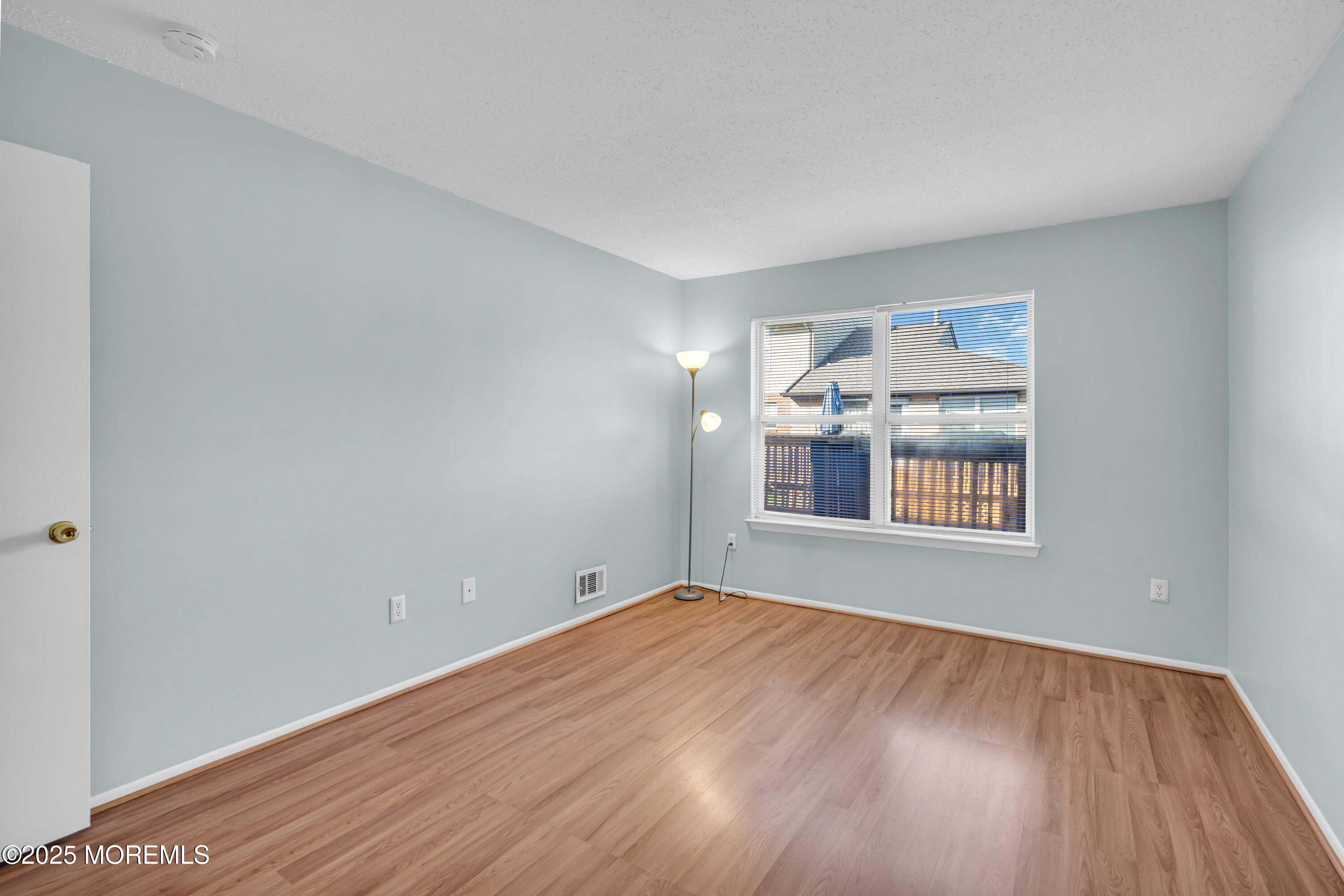 47 Kitty Court Brick, NJ 08724 - Photo 4 of 17 a view of an empty room with a window and wooden floor
