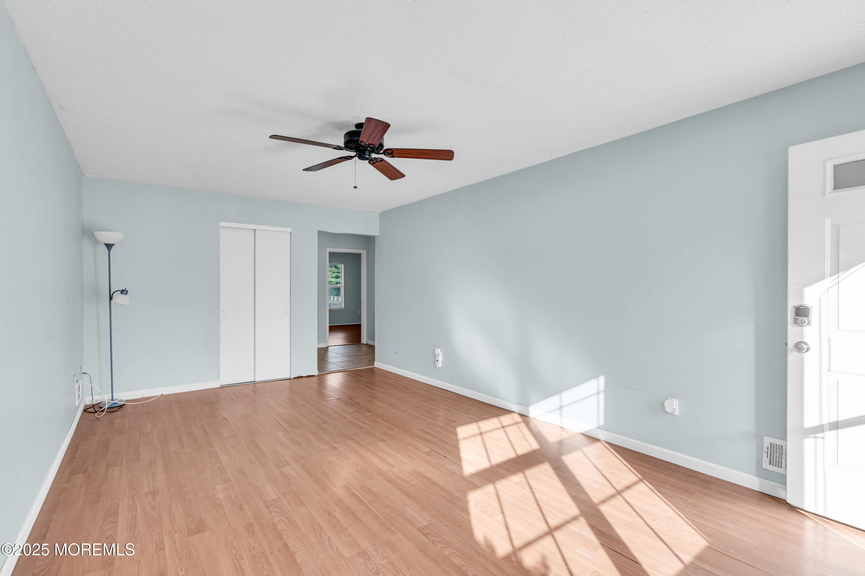 47 Kitty Court Brick, NJ 08724 - Photo 7 of 17 a view of empty room with wooden floor and fan