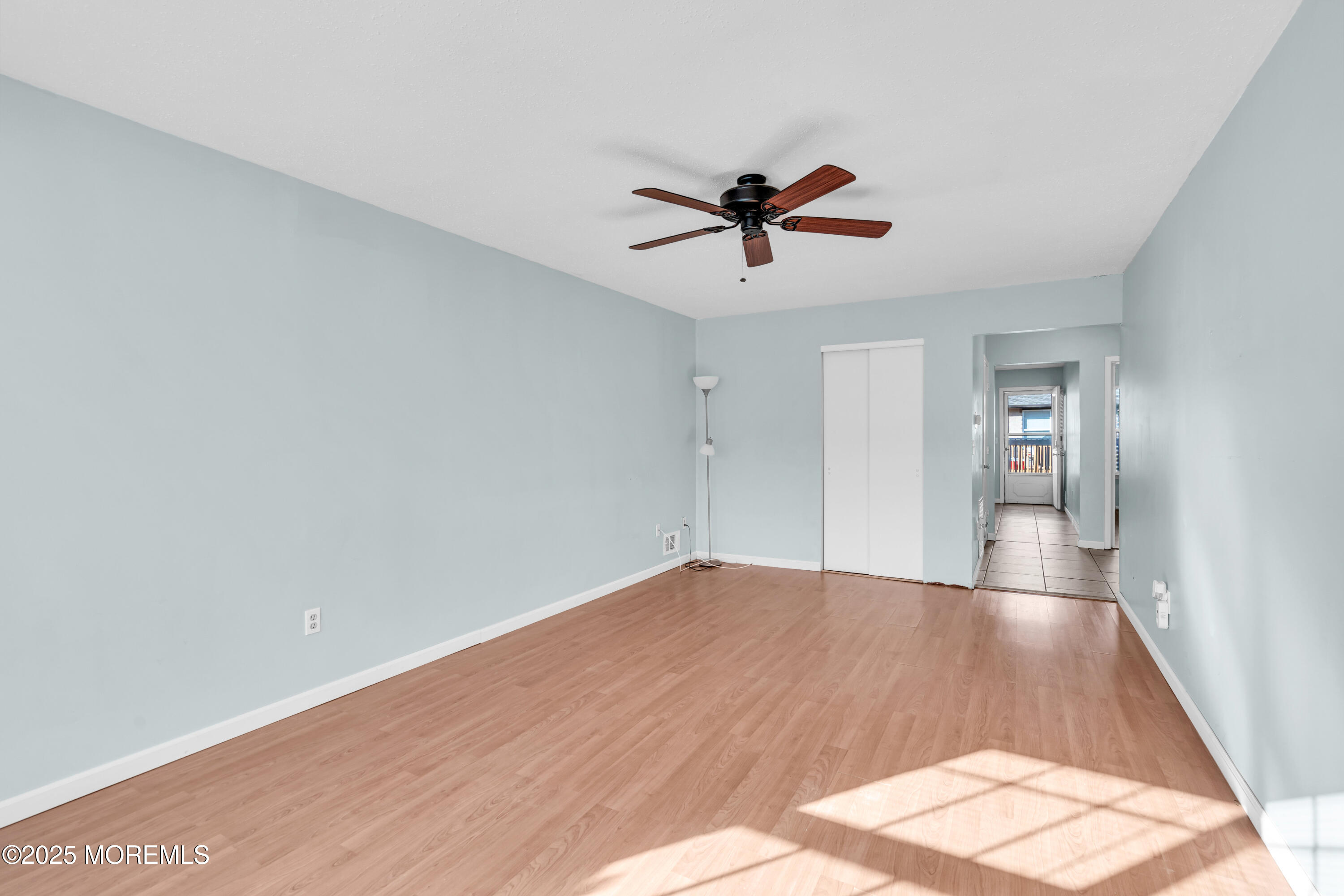 47 Kitty Court Brick, NJ 08724 - Photo 8 of 17 a view of empty room with wooden floor and ceiling fan