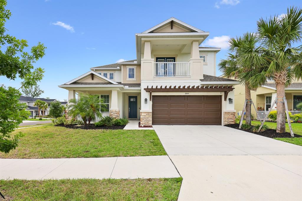 a front view of a house with a garden