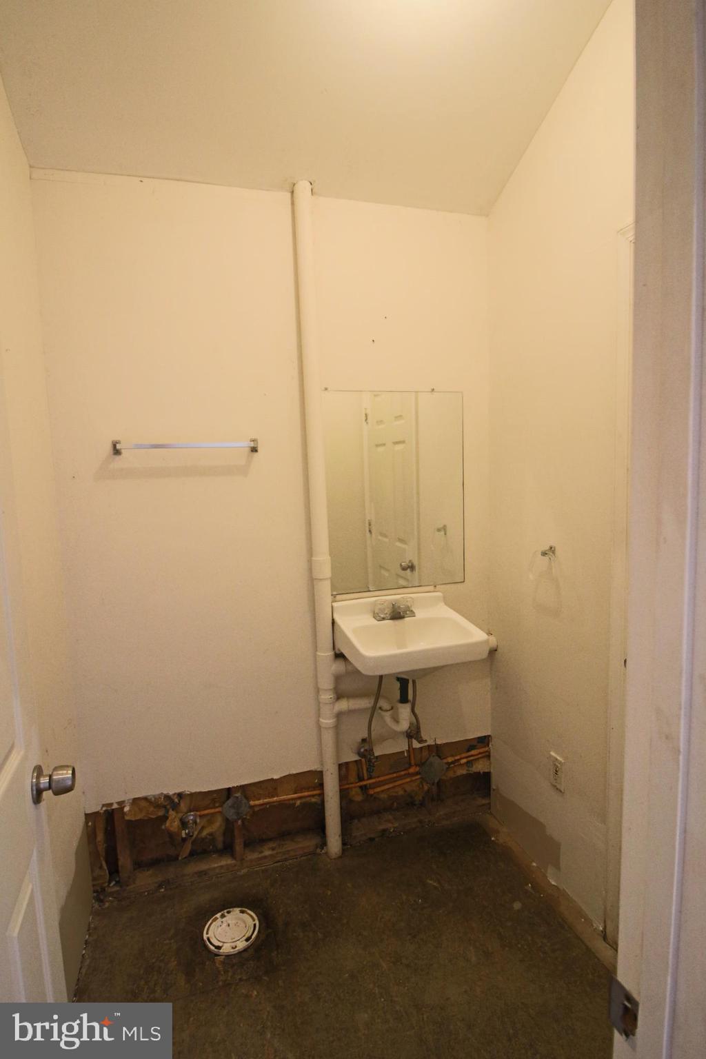 1606 Ruxton Road Edgewater, MD 21037 - Photo 21 of 26 a bathroom with a sink a toilet and a mirror