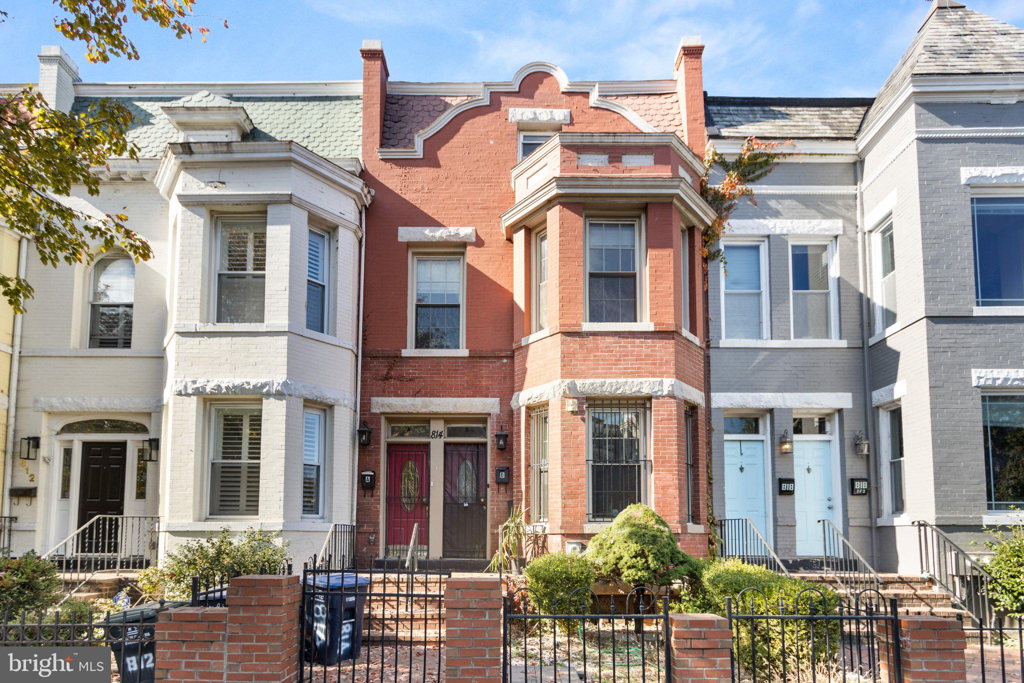 front view of a brick house with a large windows