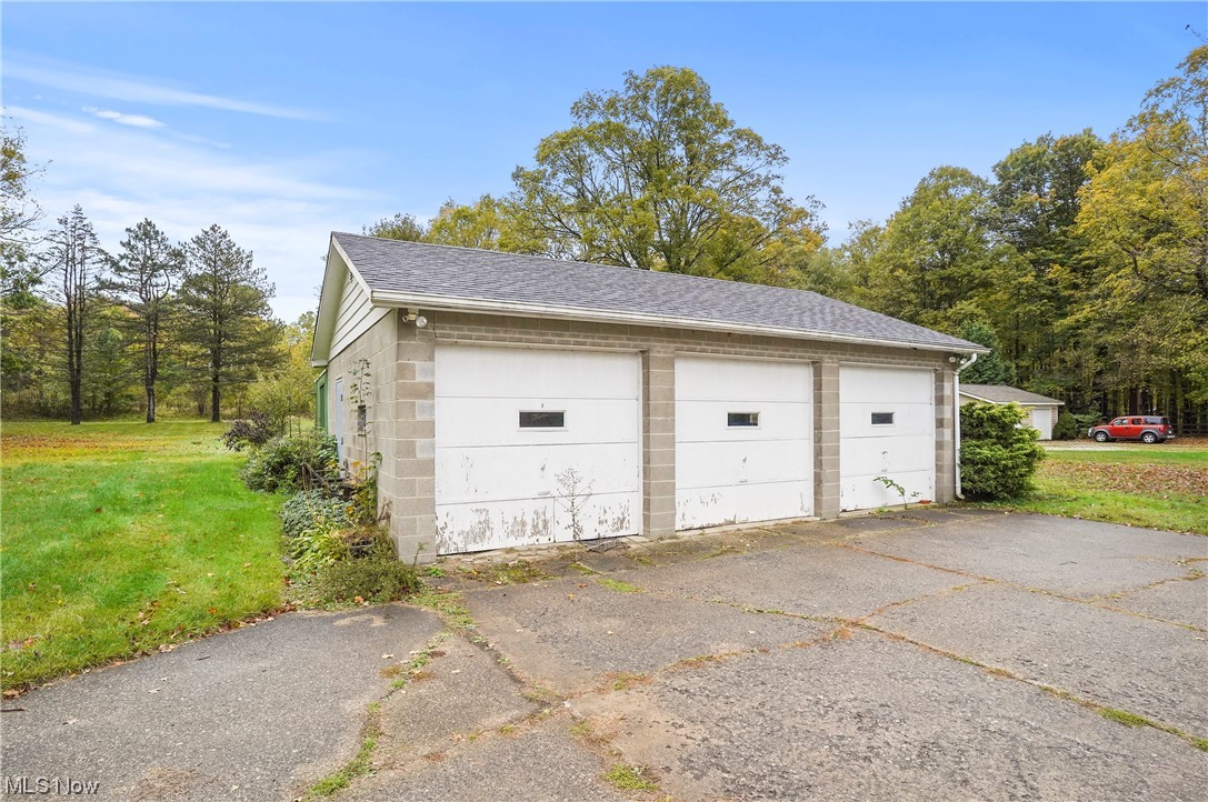 13745 Chillicothe Road Novelty, OH 44072 - Photo 7 of 31 Three car Garage featuring a yard