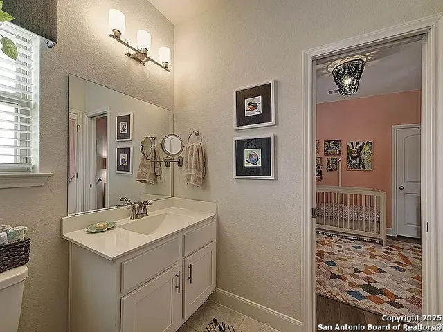 a bathroom with a sink mirror and vanity