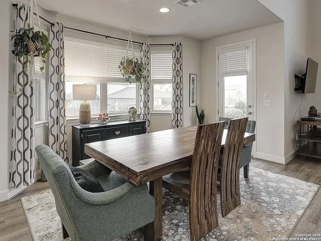 a dining room with furniture and window