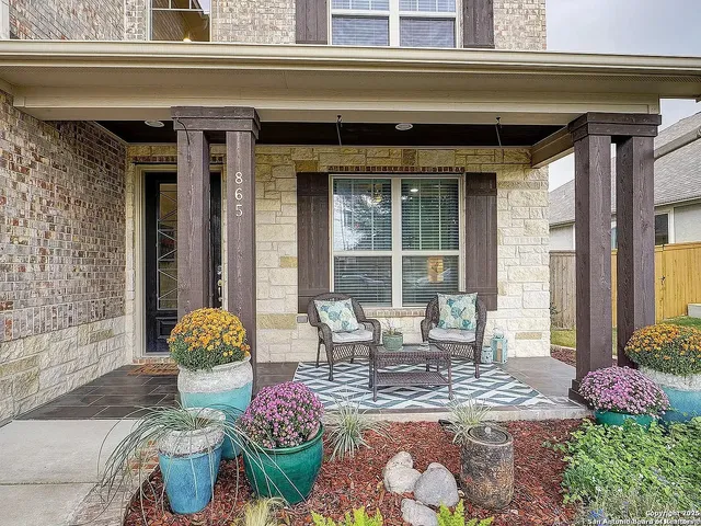 a living room filled with furniture and a potted plant