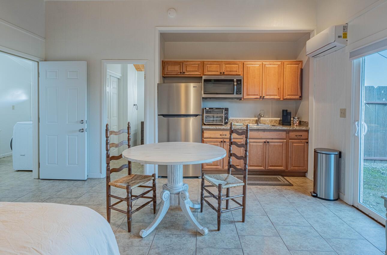 844 River Road Salinas, CA 93908 - Photo 60 of 77 a kitchen with a table chairs refrigerator and cabinets