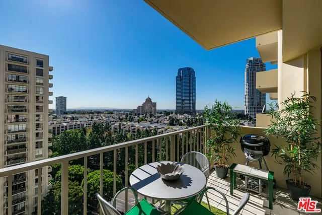 a balcony with furniture and a potted plant
