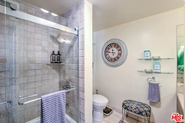 a bathroom with a toilet and a shower curtain