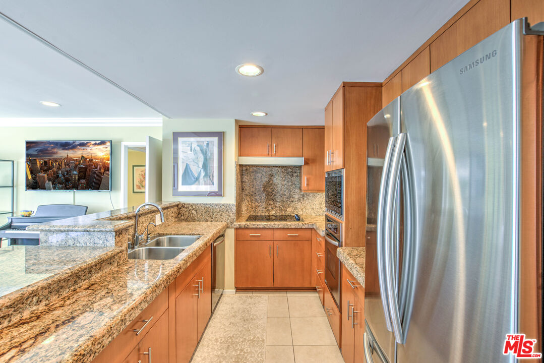 2160 Century Park East, Unit 1607 Los Angeles, CA 90067 - Photo 15 of 38 a kitchen with stainless steel appliances granite countertop a refrigerator and a sink