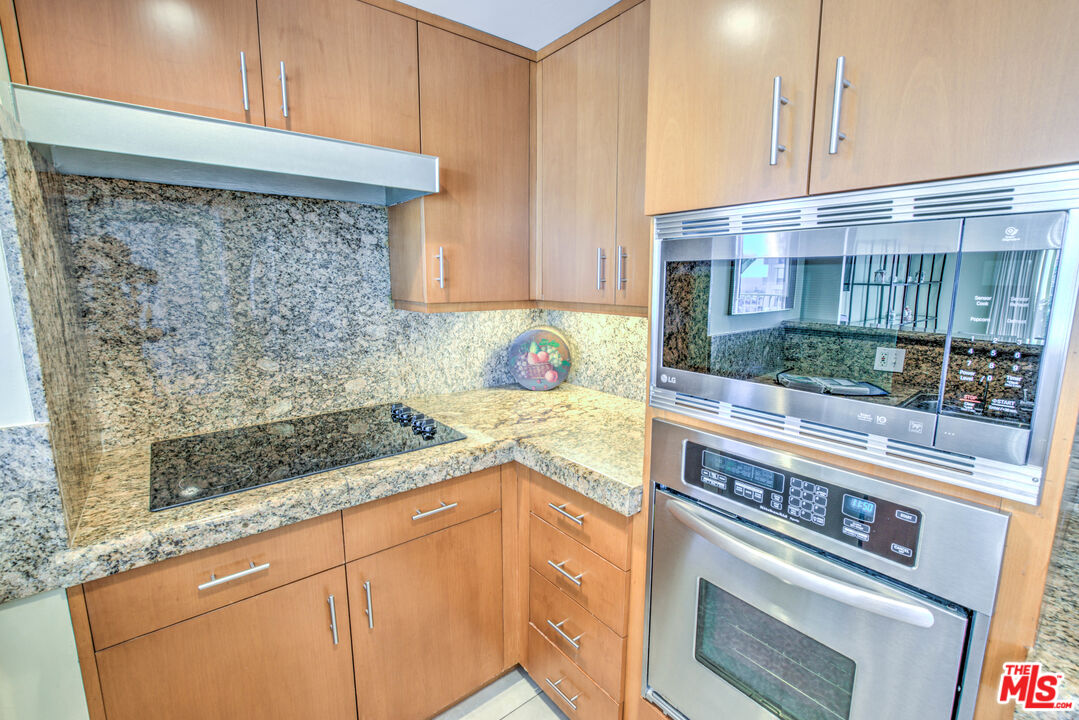 2160 Century Park East, Unit 1607 Los Angeles, CA 90067 - Photo 17 of 38 a kitchen with granite countertop a stove and a sink