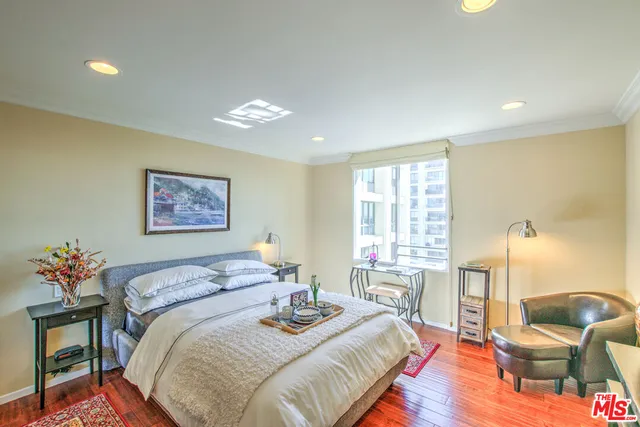 a bedroom with a bed and a bookshelf