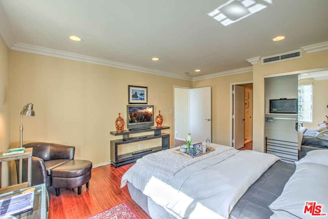 2160 Century Park East, Unit 1607 Los Angeles, CA 90067 - Photo 23 of 38 a bedroom with a bed and furniture