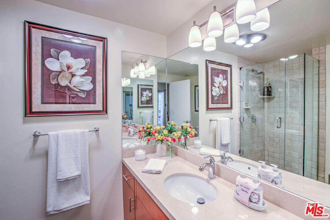 2160 Century Park East, Unit 1607 Los Angeles, CA 90067 - Photo 25 of 38 a bathroom with a sink vanity and a mirror