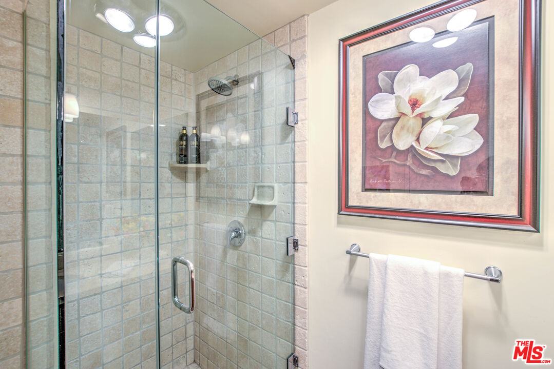 2160 Century Park East, Unit 1607 Los Angeles, CA 90067 - Photo 26 of 38 a bathroom with a picture bed and a shower